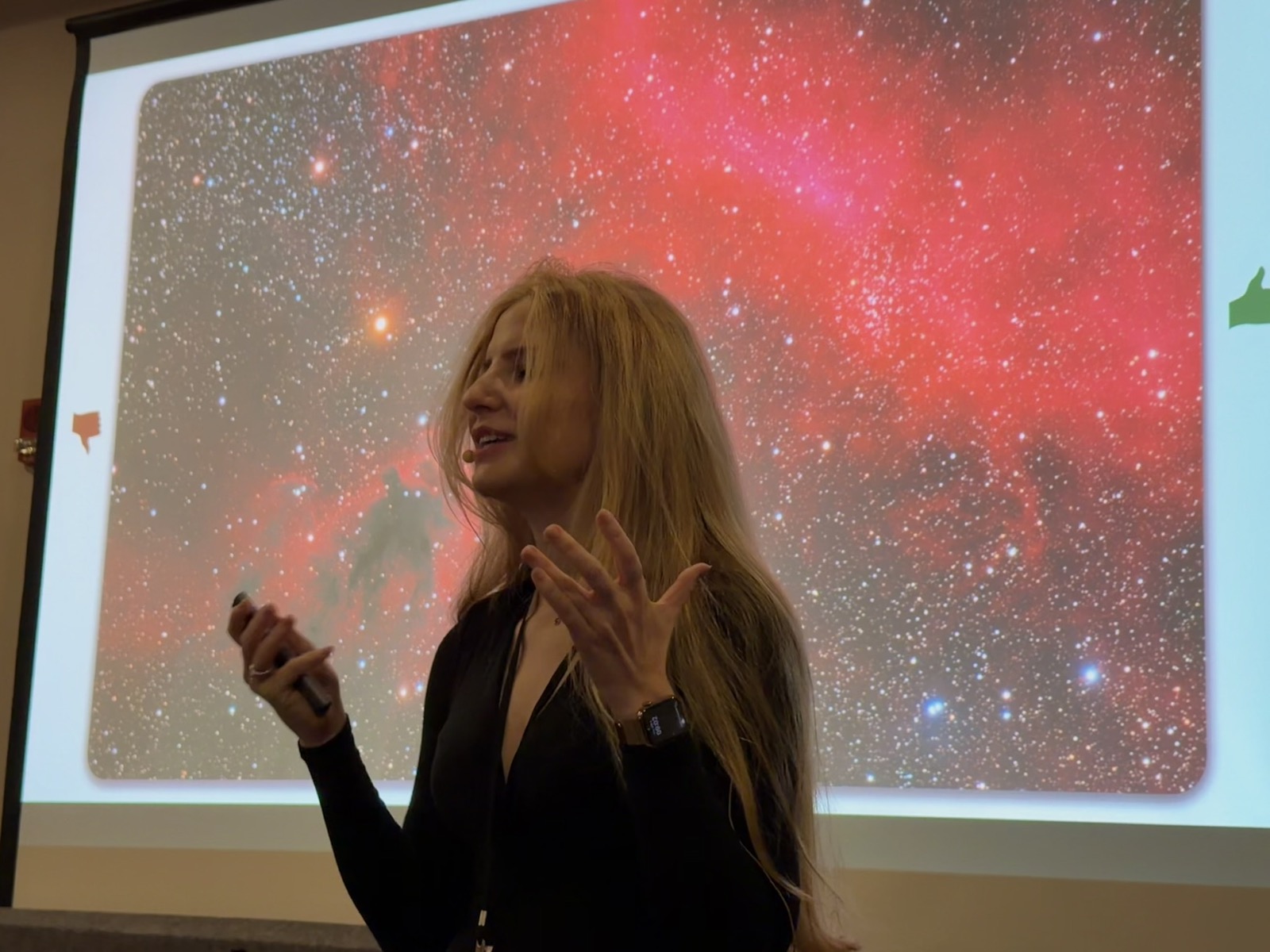 Luca presenting in front of an astrophotography image during an astronomy talk
